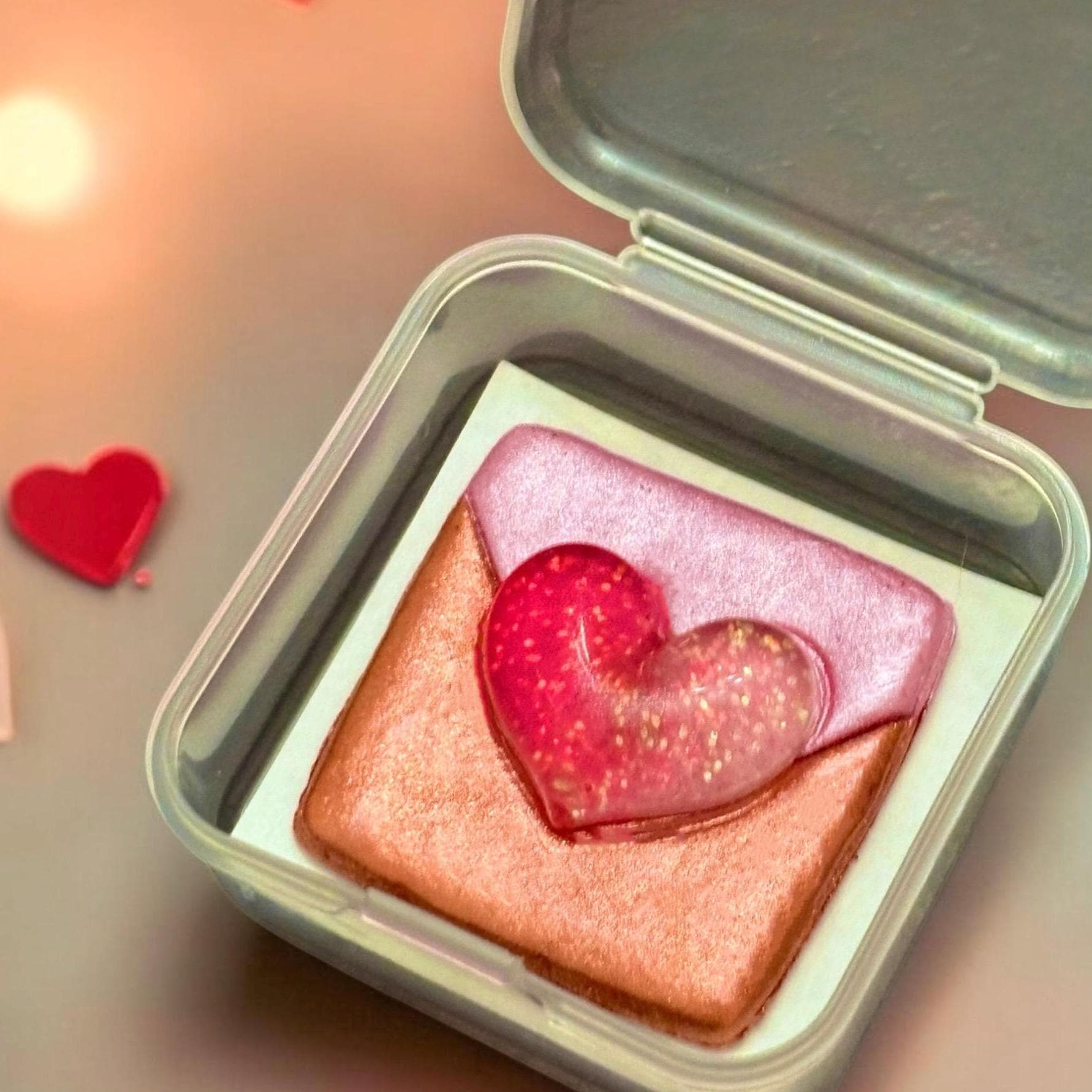 Makeup product with a heart-shaped design on a blurred background