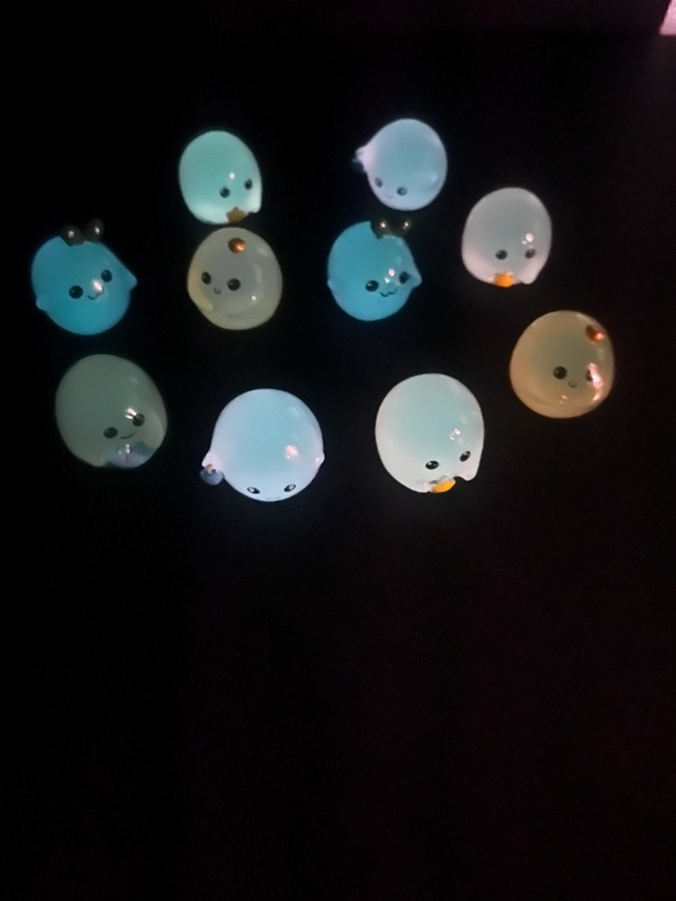 Small round toys with faces on a dark background