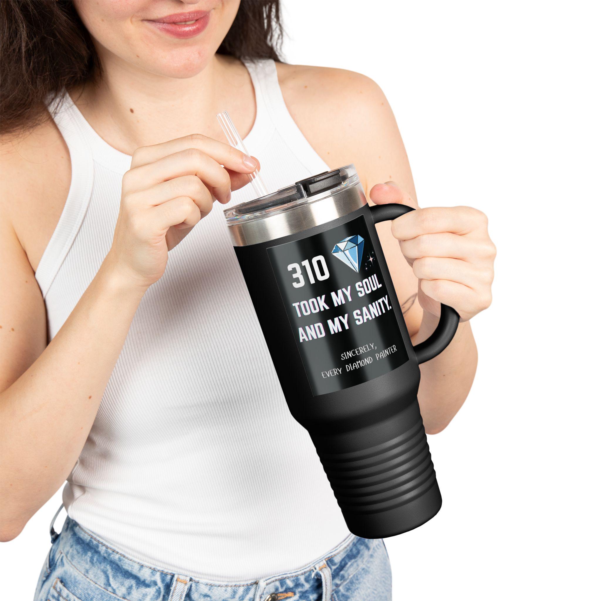 Person holding a black travel mug with text