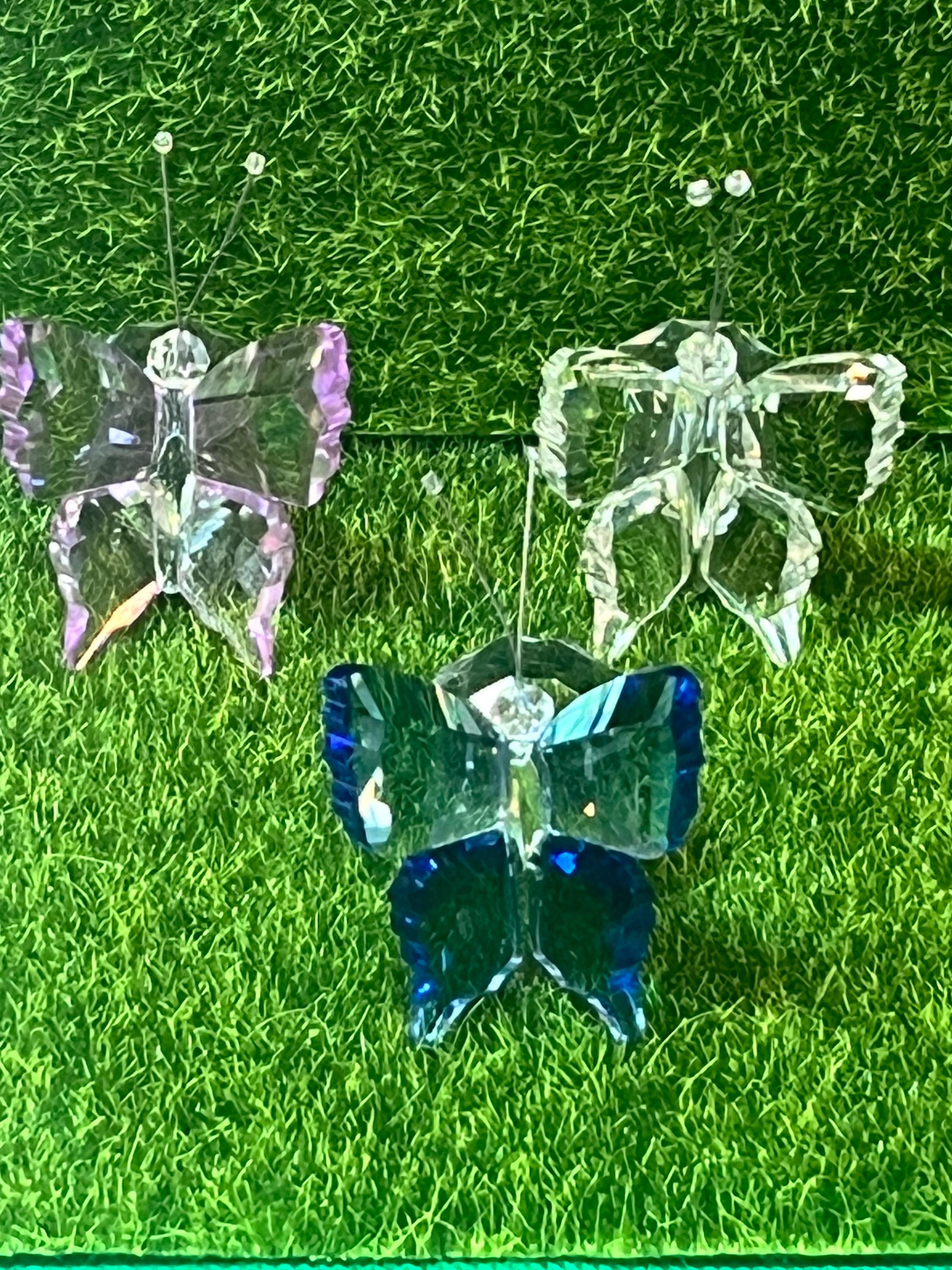 Crystal butterflies on a grassy background