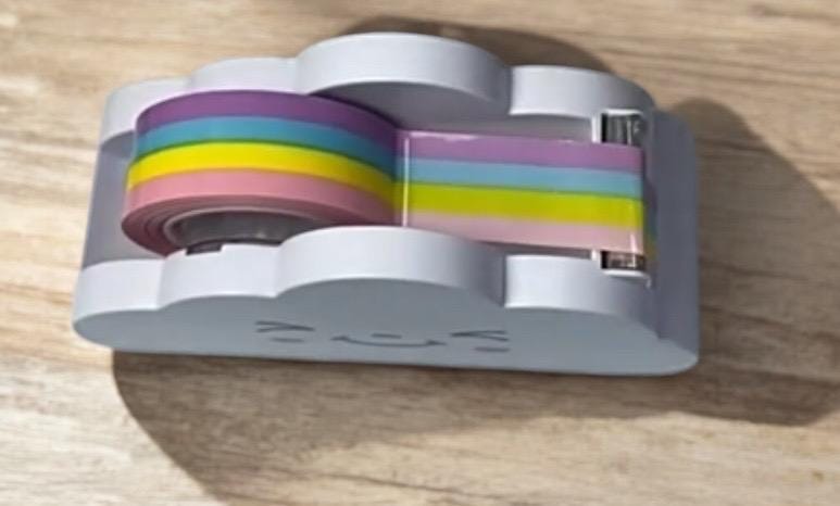 Small, colorful device with a cat face design on a wooden surface