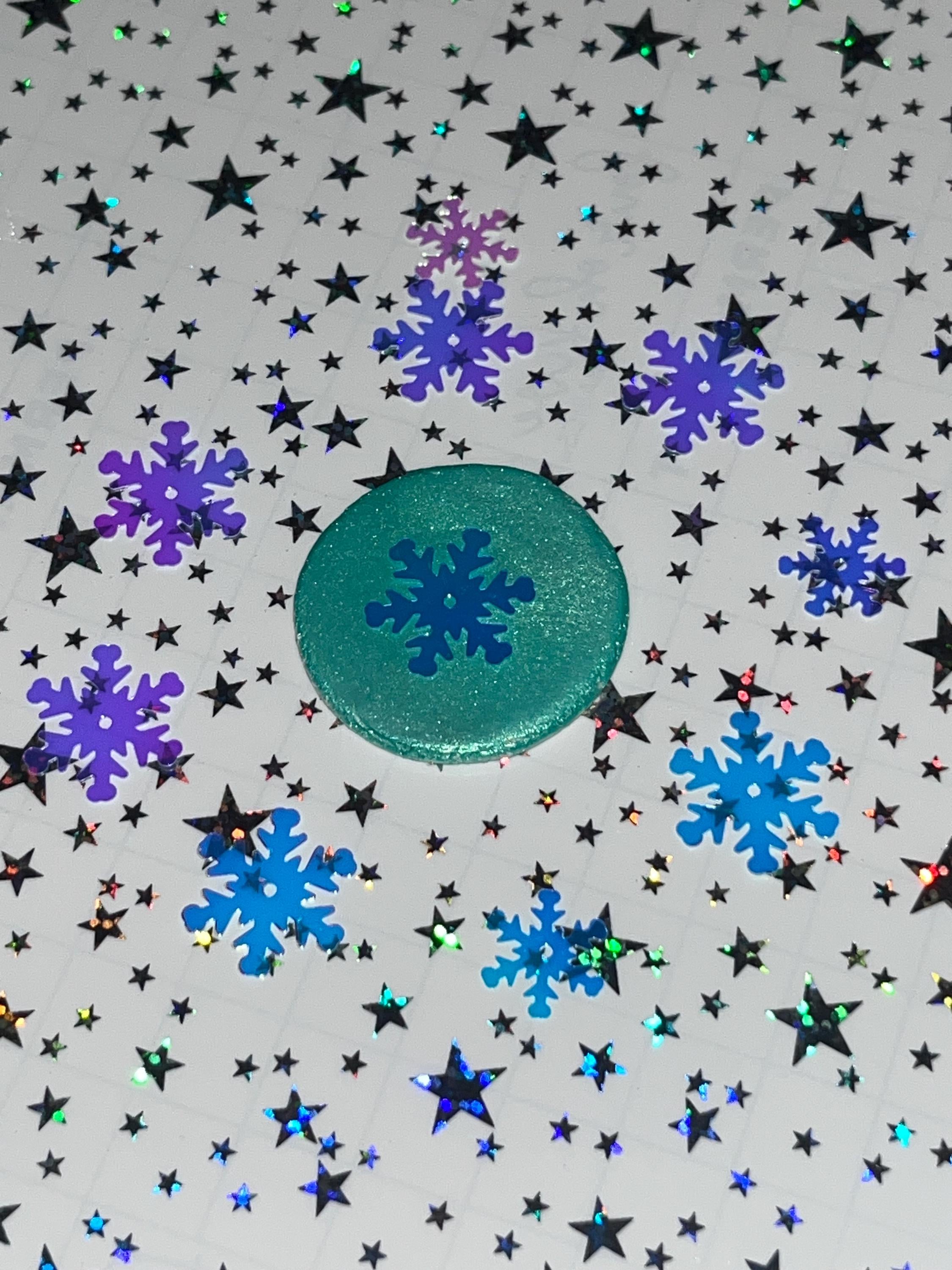 Decorative paper with blue snowflakes and stars on a gray background