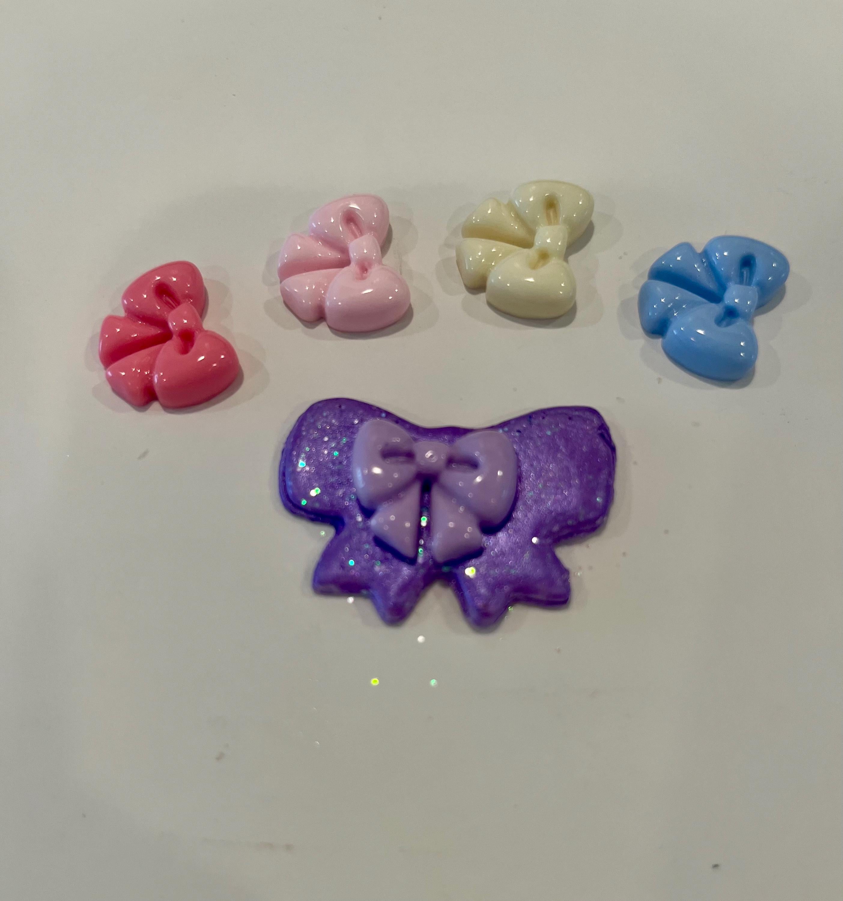 Set of colorful bow-shaped decorative items on a white background