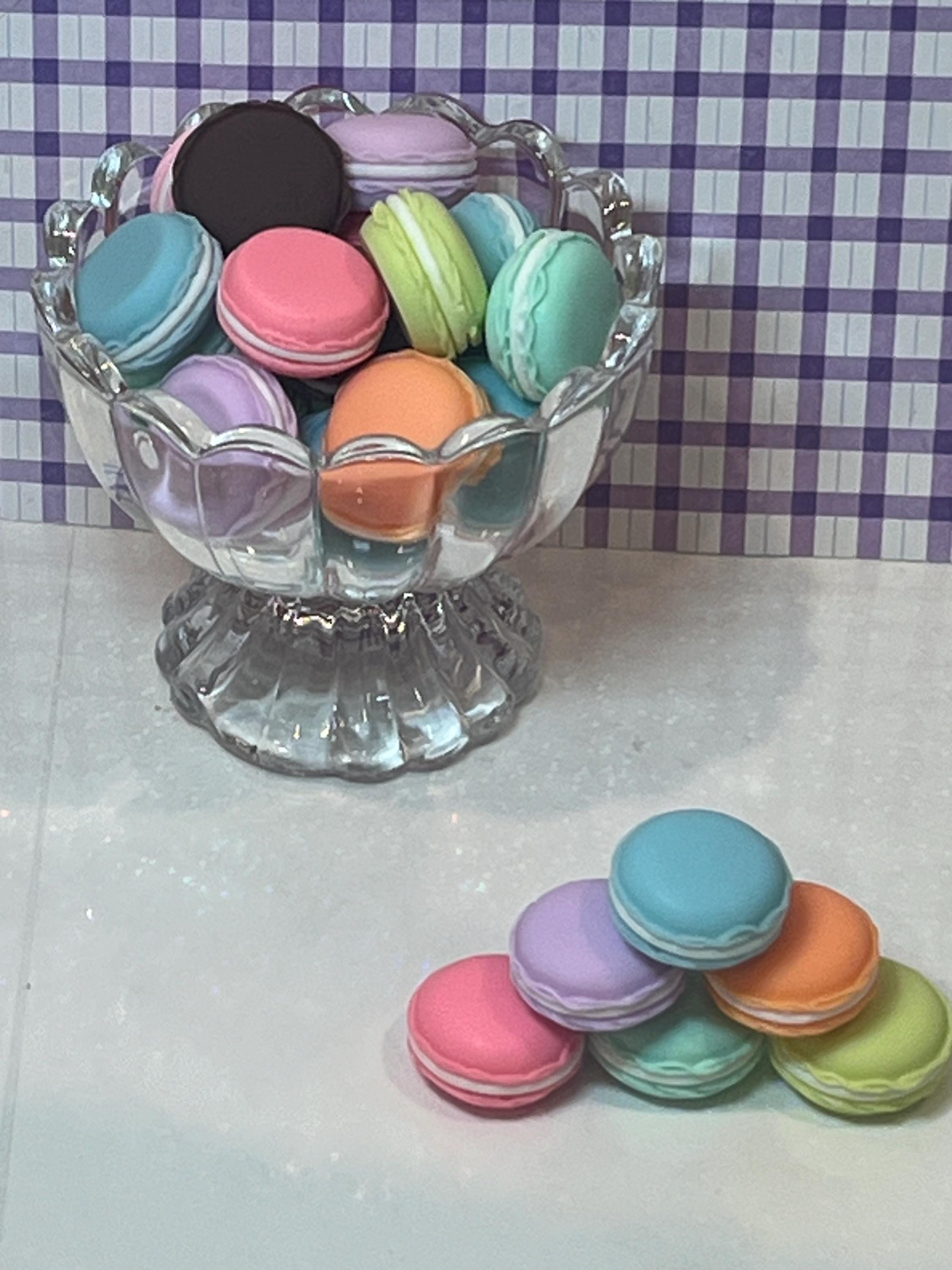 Colorful macarons in a glass dish on a checkered tablecloth