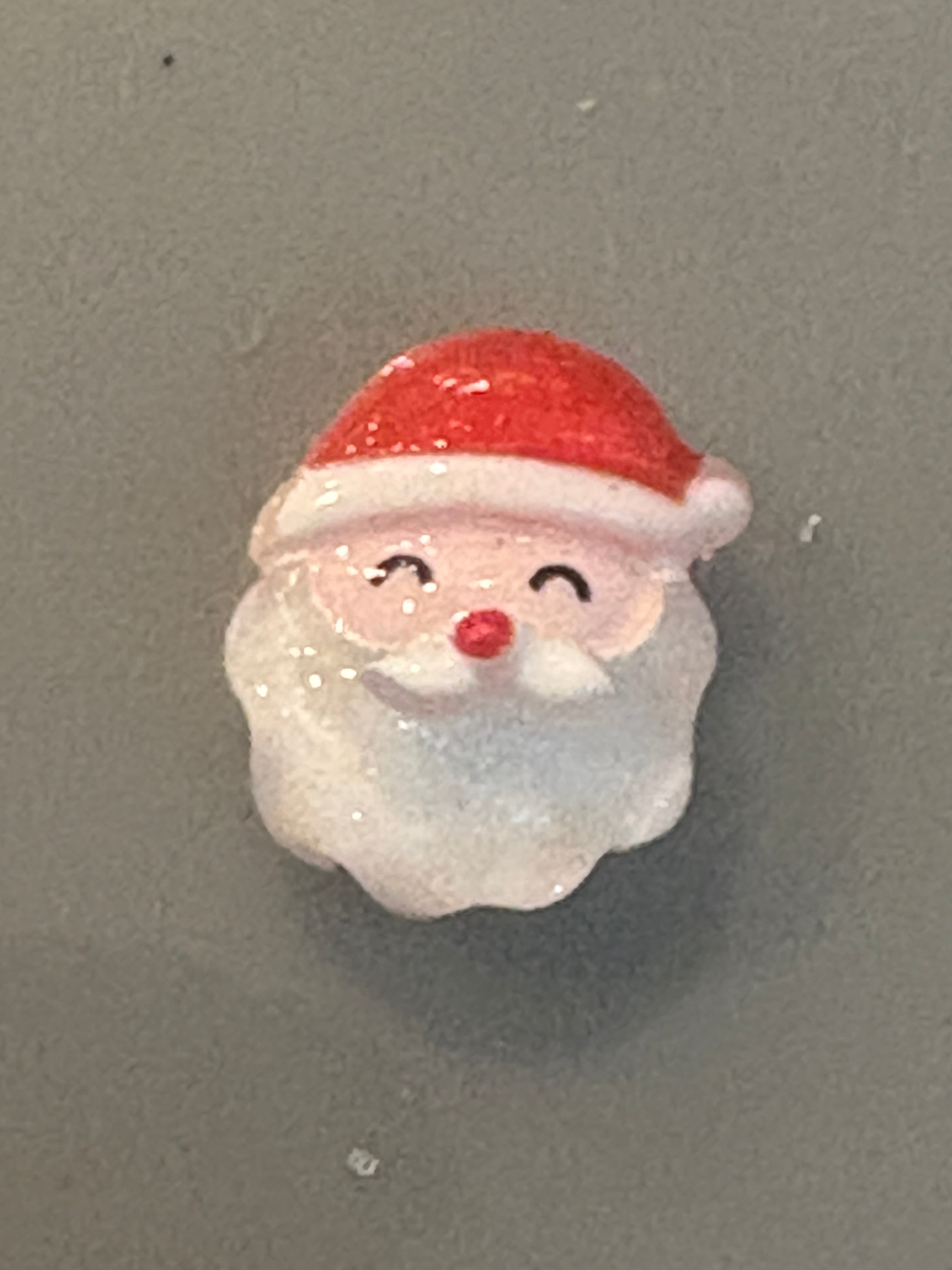 Seashell with a painted face on a gray background
