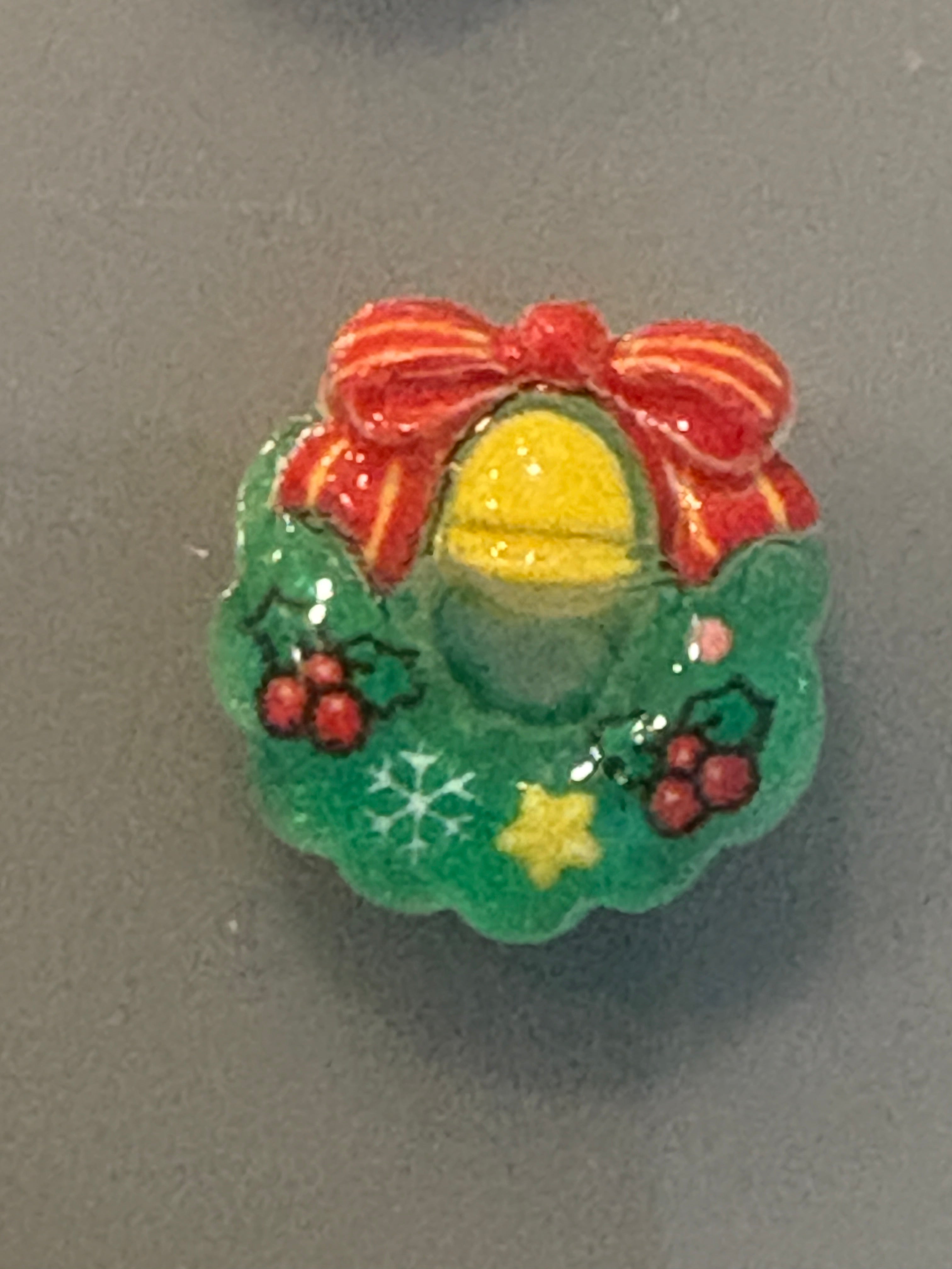 Decorative button with floral design on a gray background