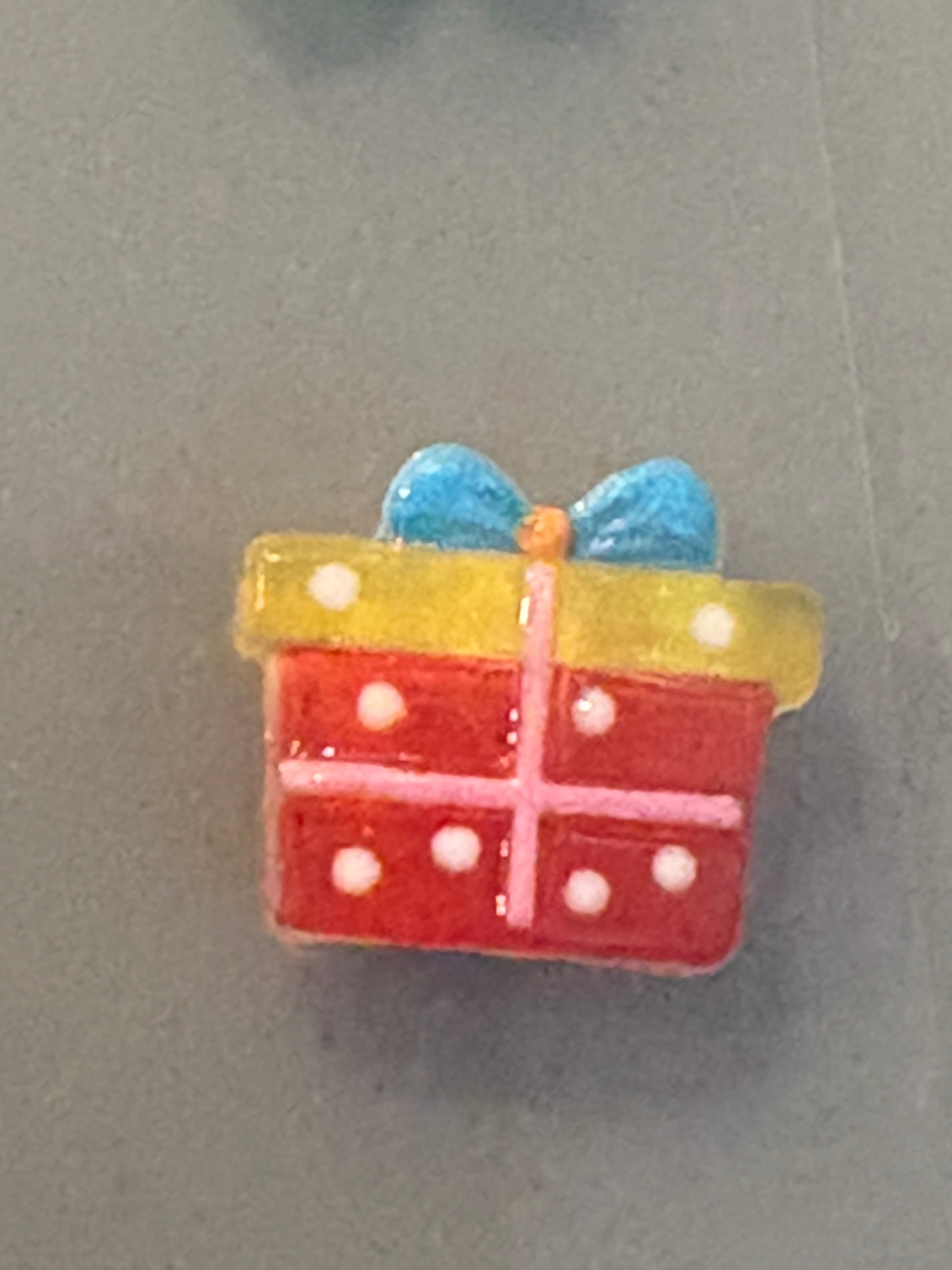 Colorful gift-shaped object with a blue bow on a gray background