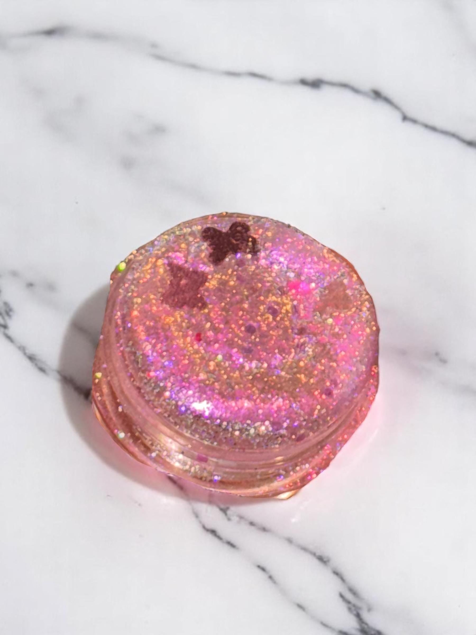 Pink glittery container on a marble surface