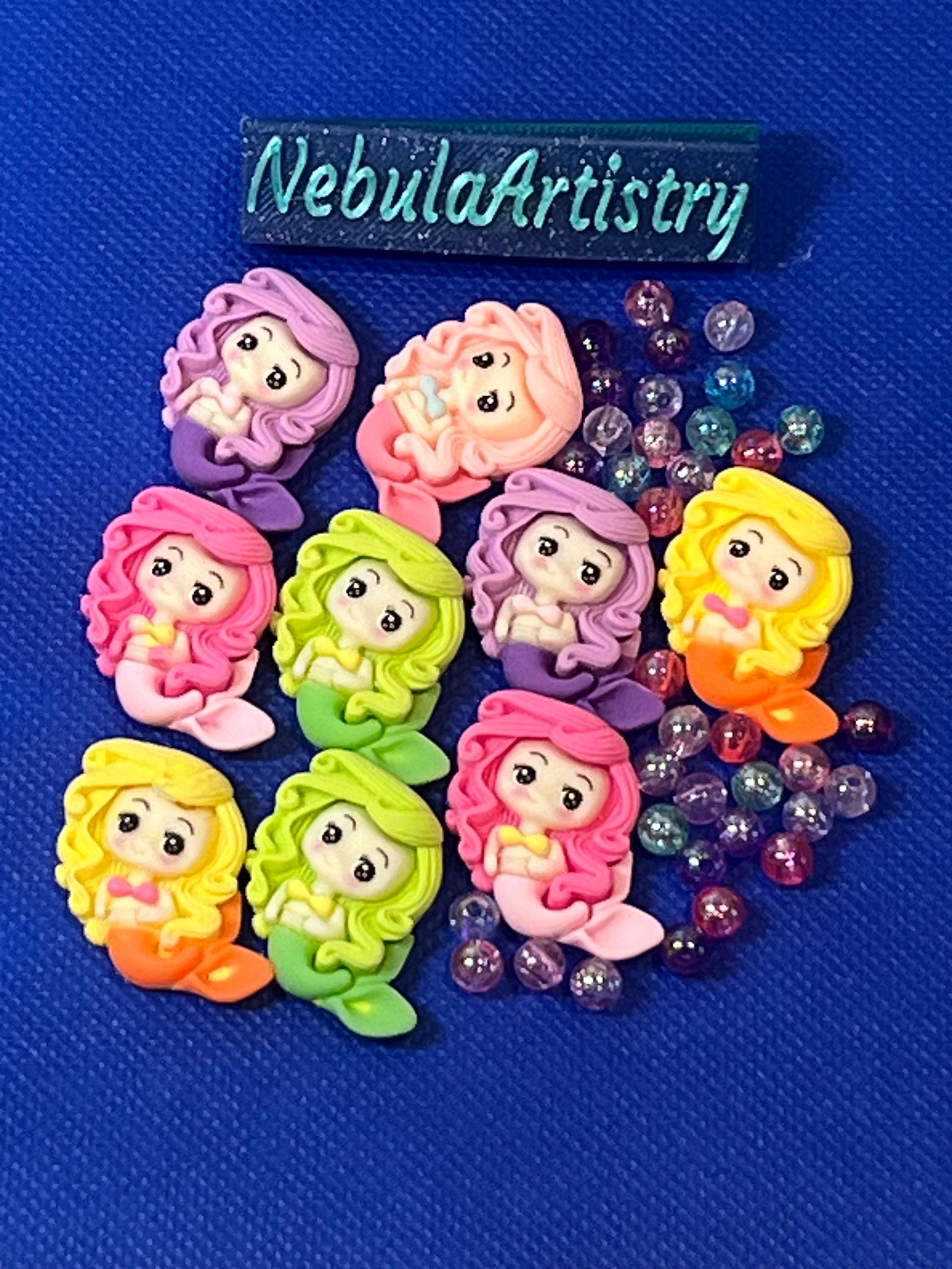 Colorful mermaid figurines with beads on a blue background, branded 'NebulaArtistry'.