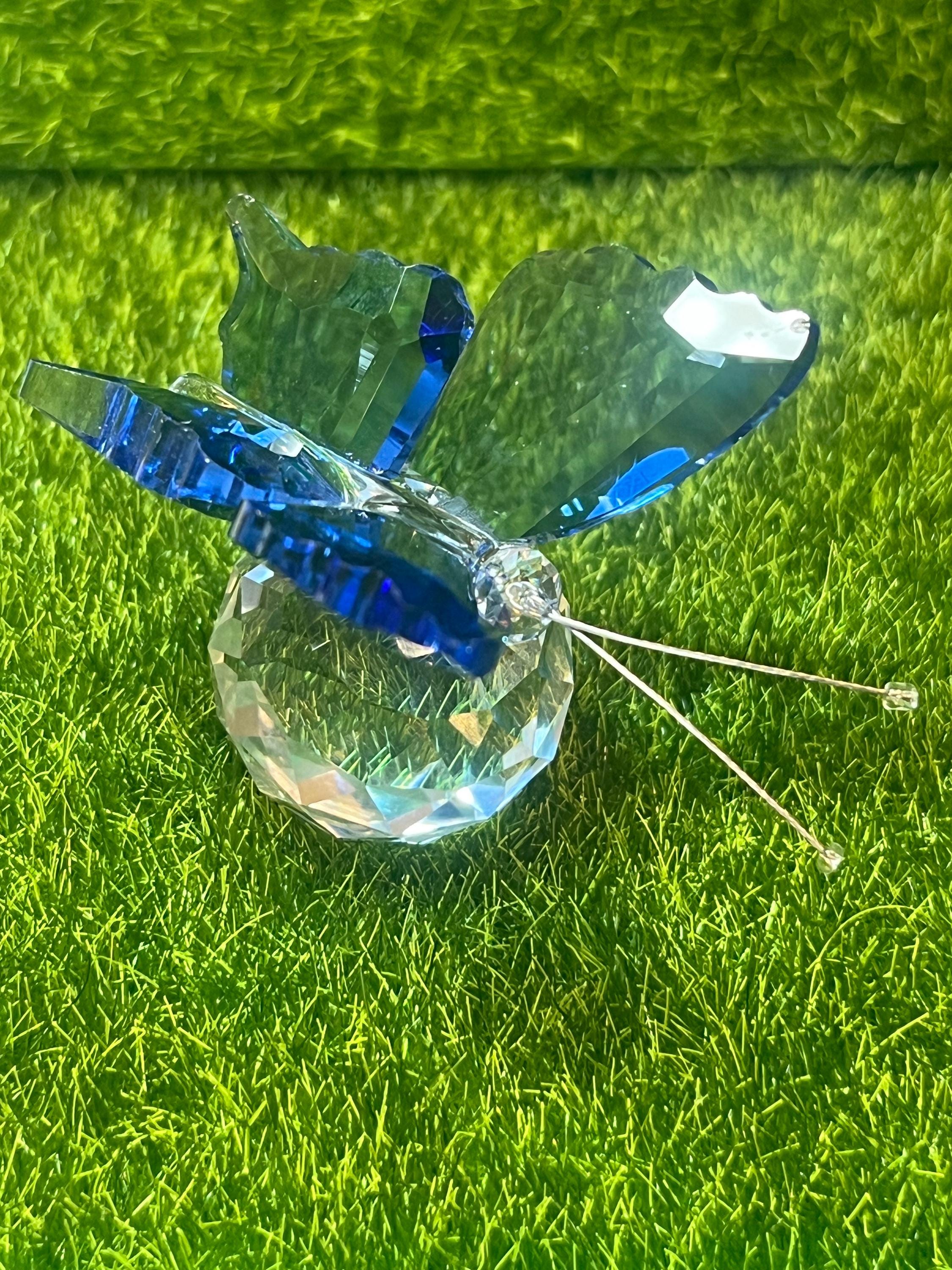 Crystal butterfly ornament on a green grass background