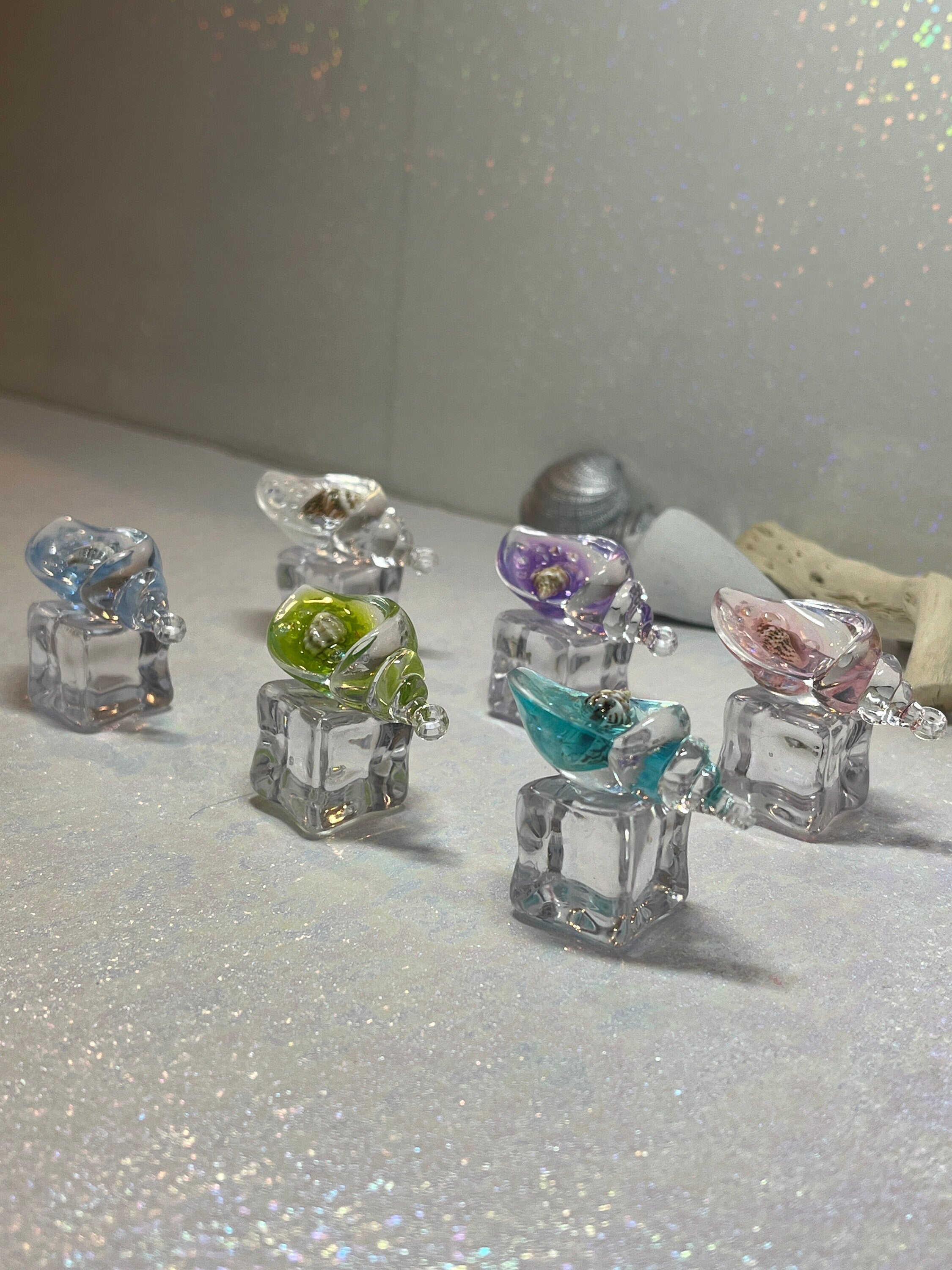Small glass figurines on a glittery surface