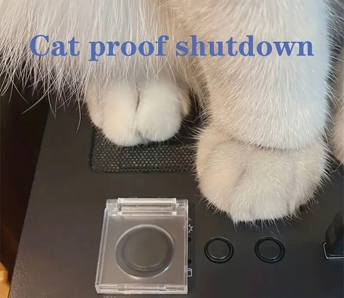 Clear electronic device on a surface with cat paws and text 'Cat proof shutdown' above.